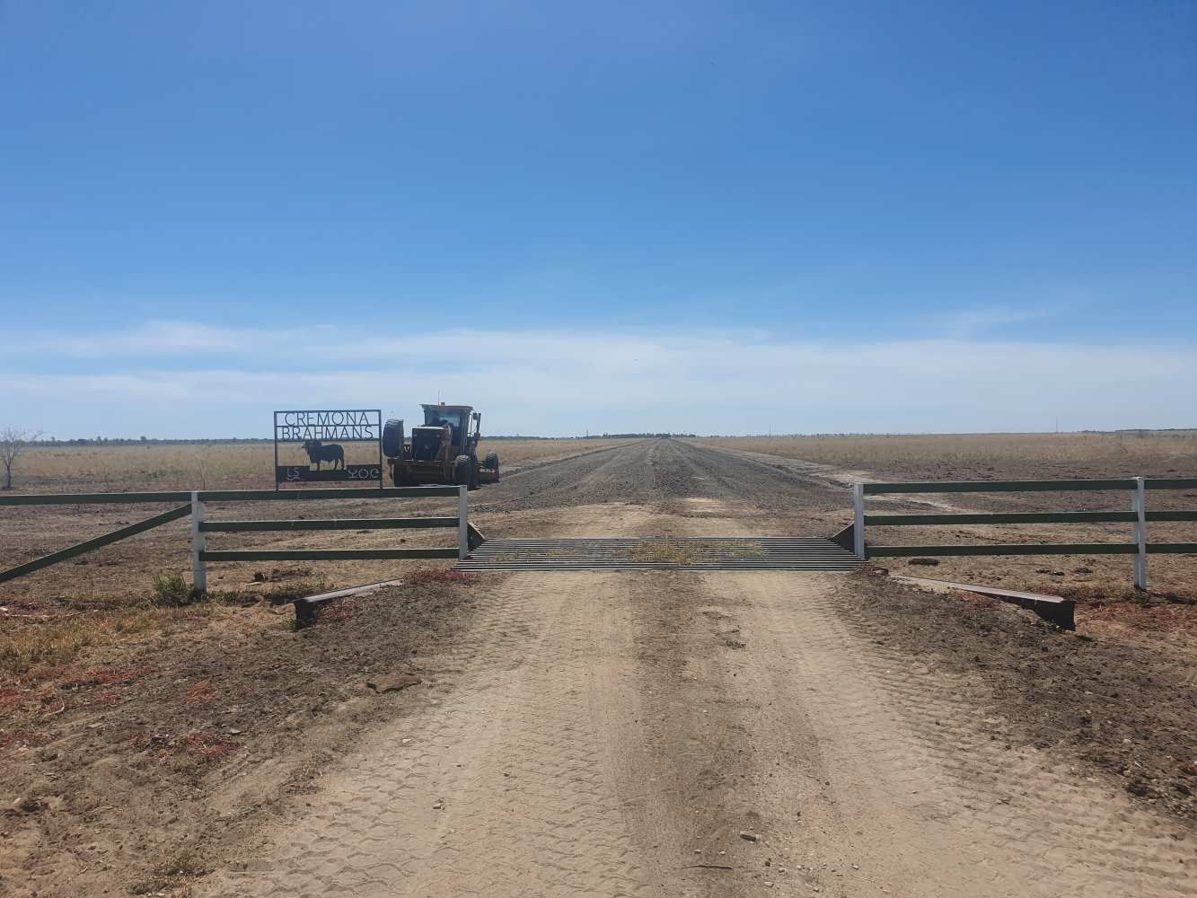 A Dirt Road With a Gate in the Middle of It — Burnett Contracting in Cloncurry, QLD