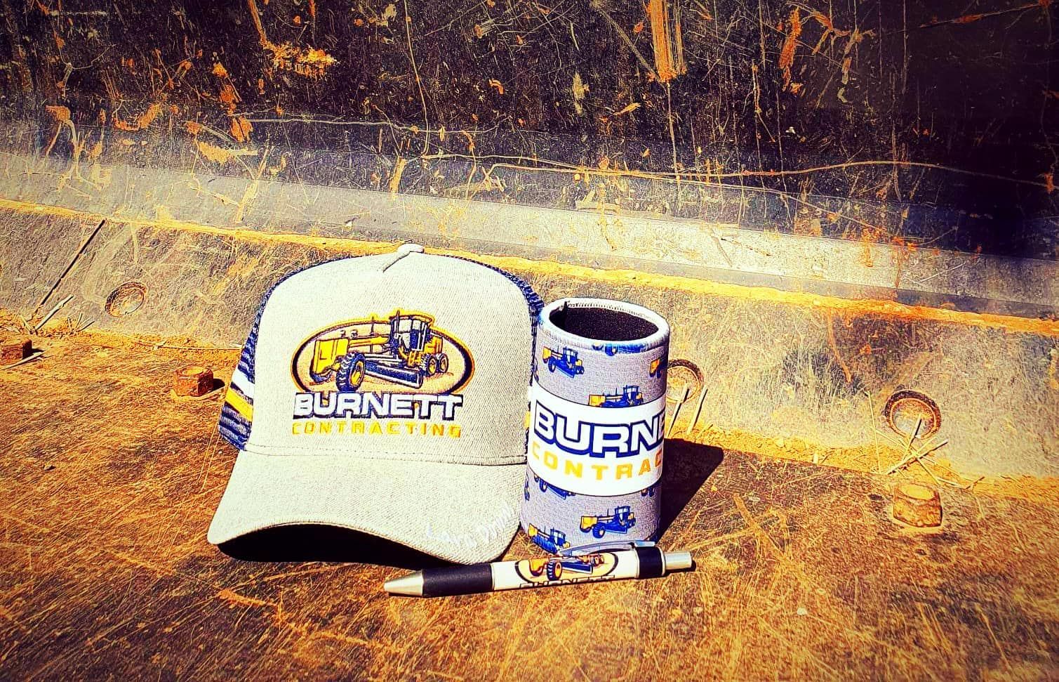 Hat, Koozie and Pen With Burnett Engineering Logo — Burnett Contracting in Cloncurry, QLD
