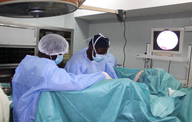 Two surgeons are operating on a patient in an operating room