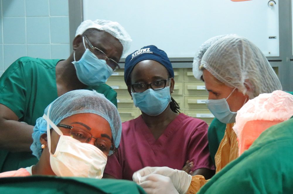 A group of surgeons wearing surgical masks and caps including one that says xtreme