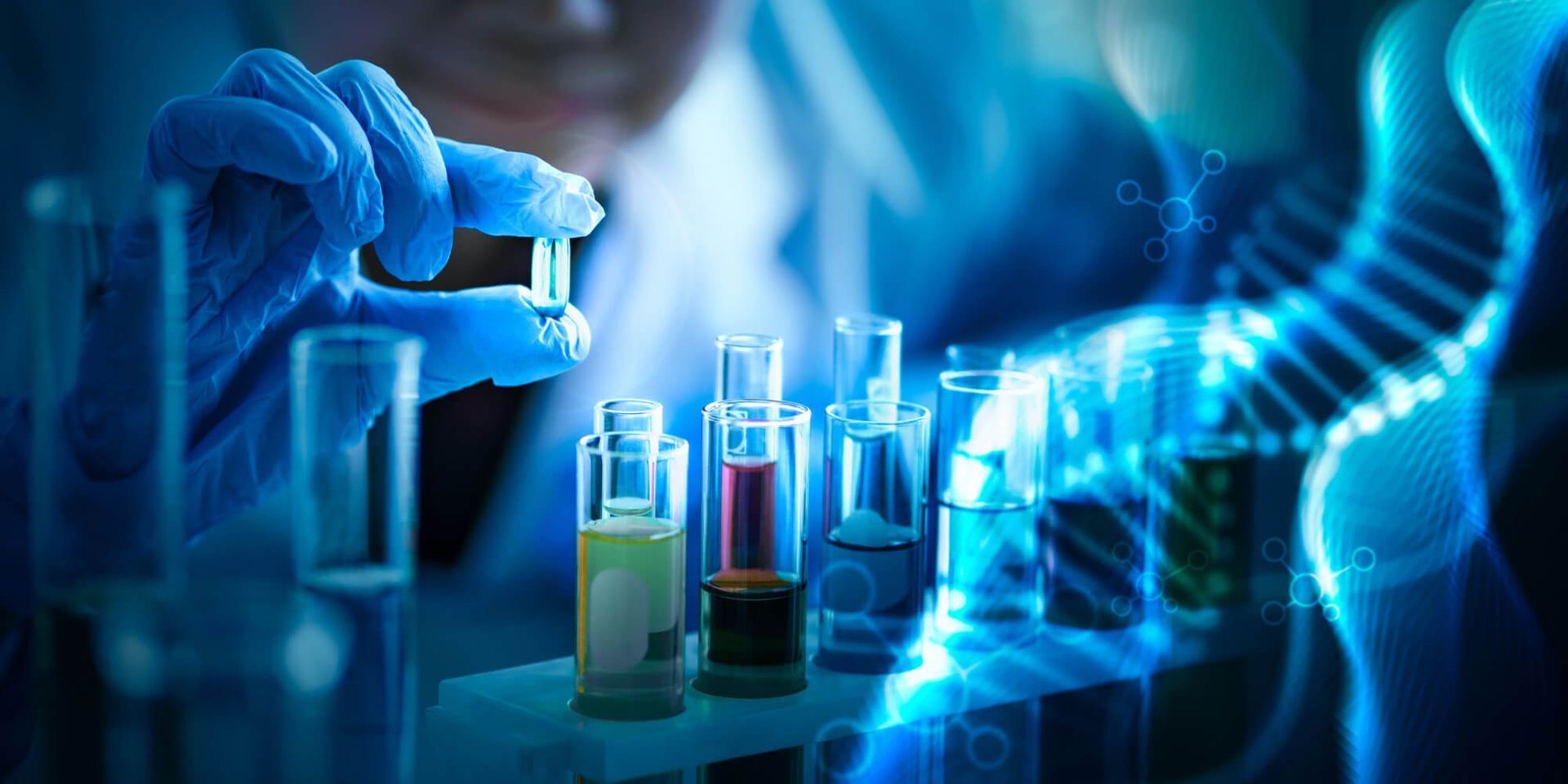 A scientist is holding a bottle of liquid in a laboratory.