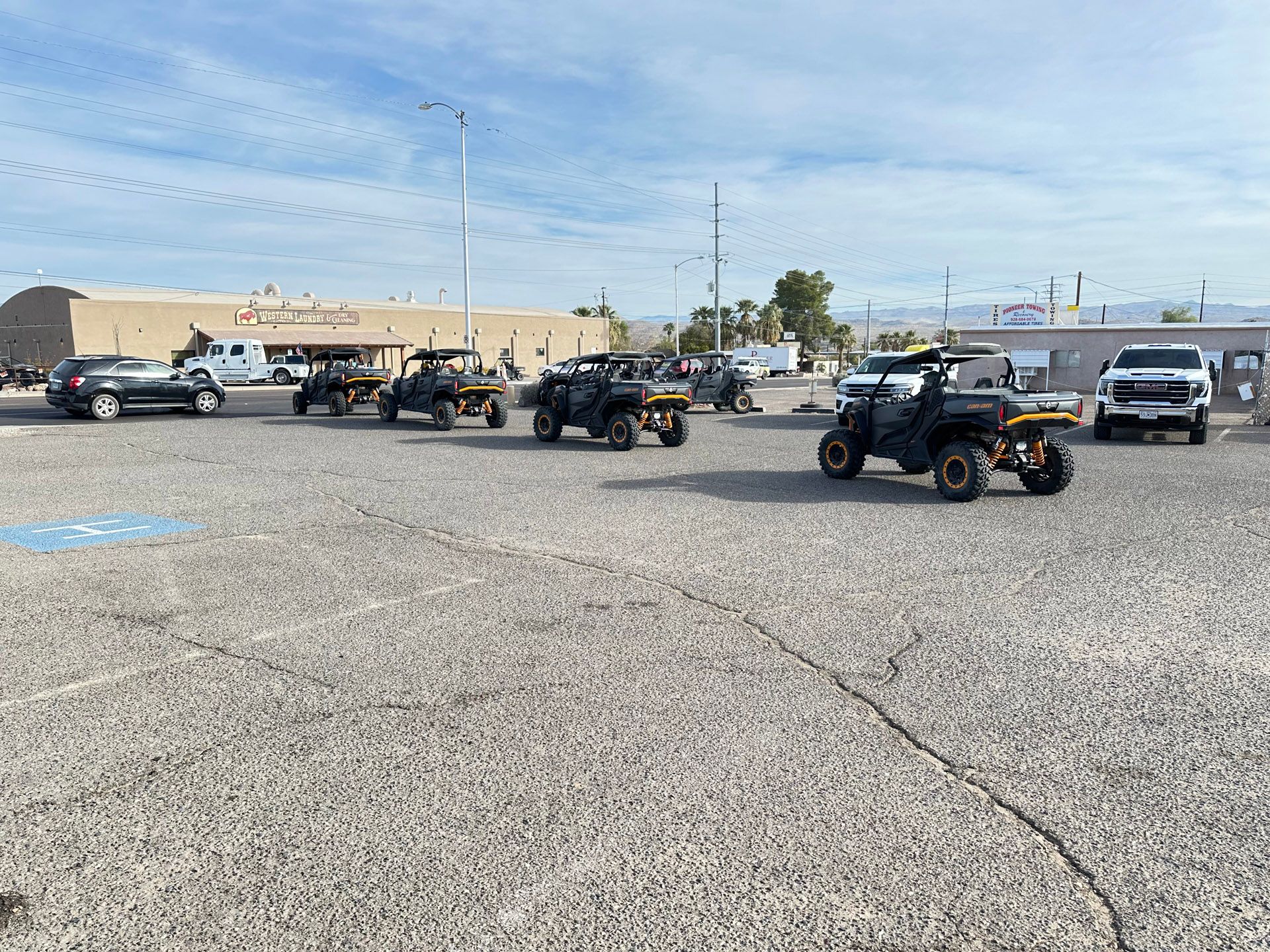 A group of atvs are parked in a parking lot.