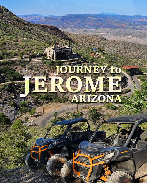 Two atvs are parked next to each other on a dirt road.