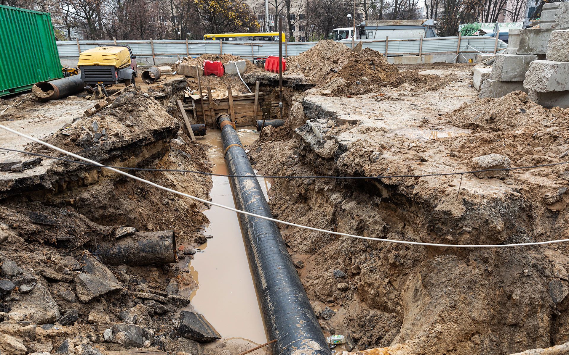 A pipe is being installed in a hole in the ground.