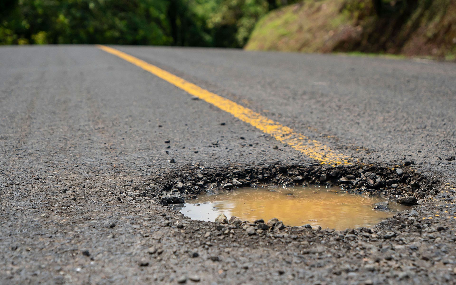 There is a pothole in the middle of the road.