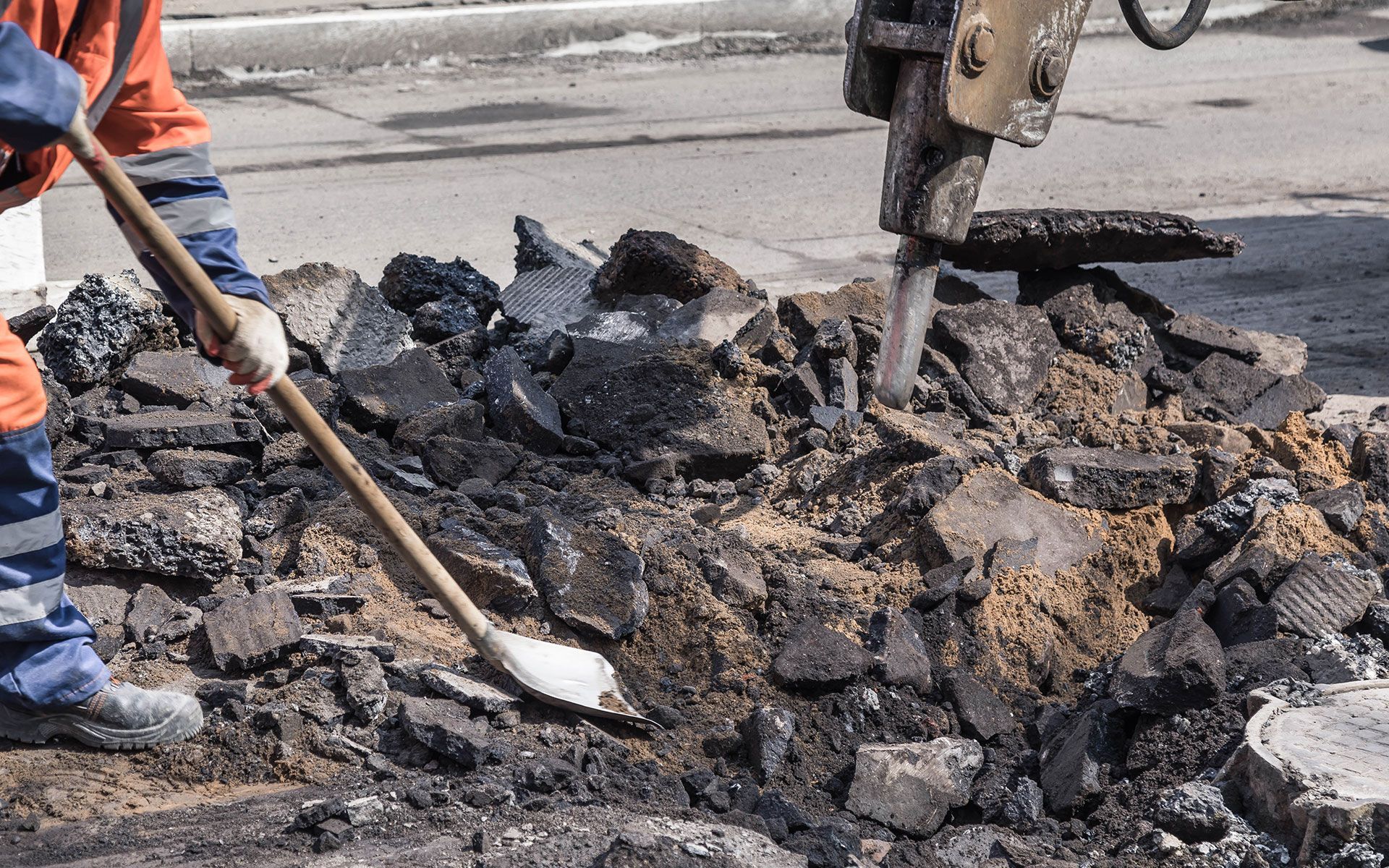 A man is using a shovel to dig a hole in the ground.