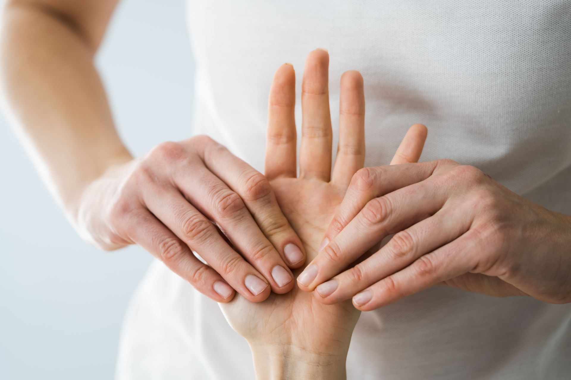 a woman is giving a hand massage to another woman