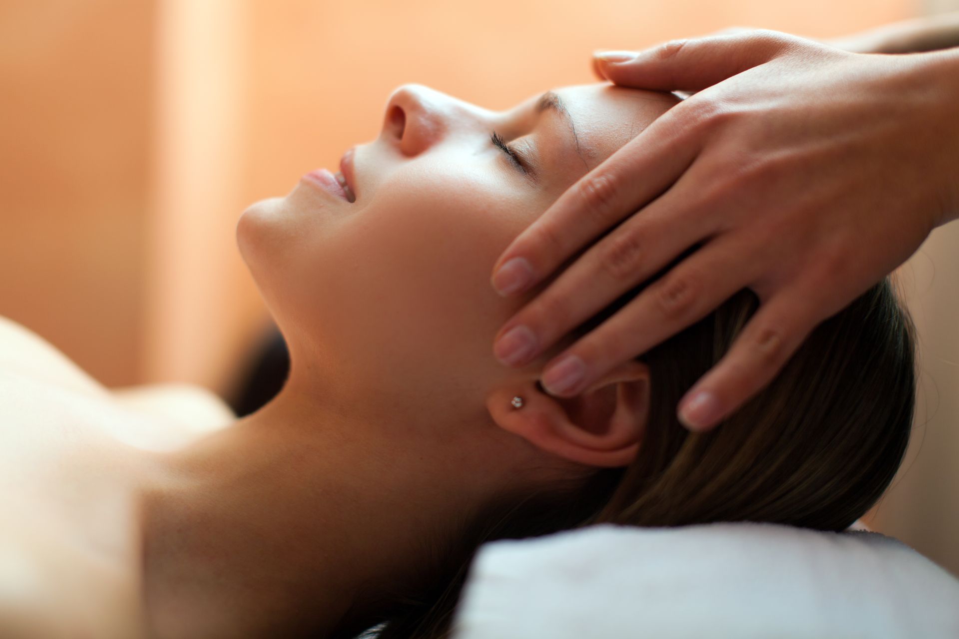 a woman is getting a head massage at a spa