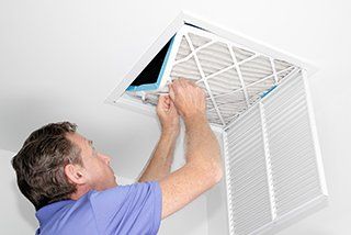 Air Conditioning Contractor - Man Removing Dirty Air Filter in Mauldin, SC