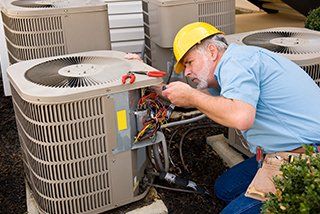 Broken AC - Repairman Works On Air Conditioning Unit in Mauldin, SC