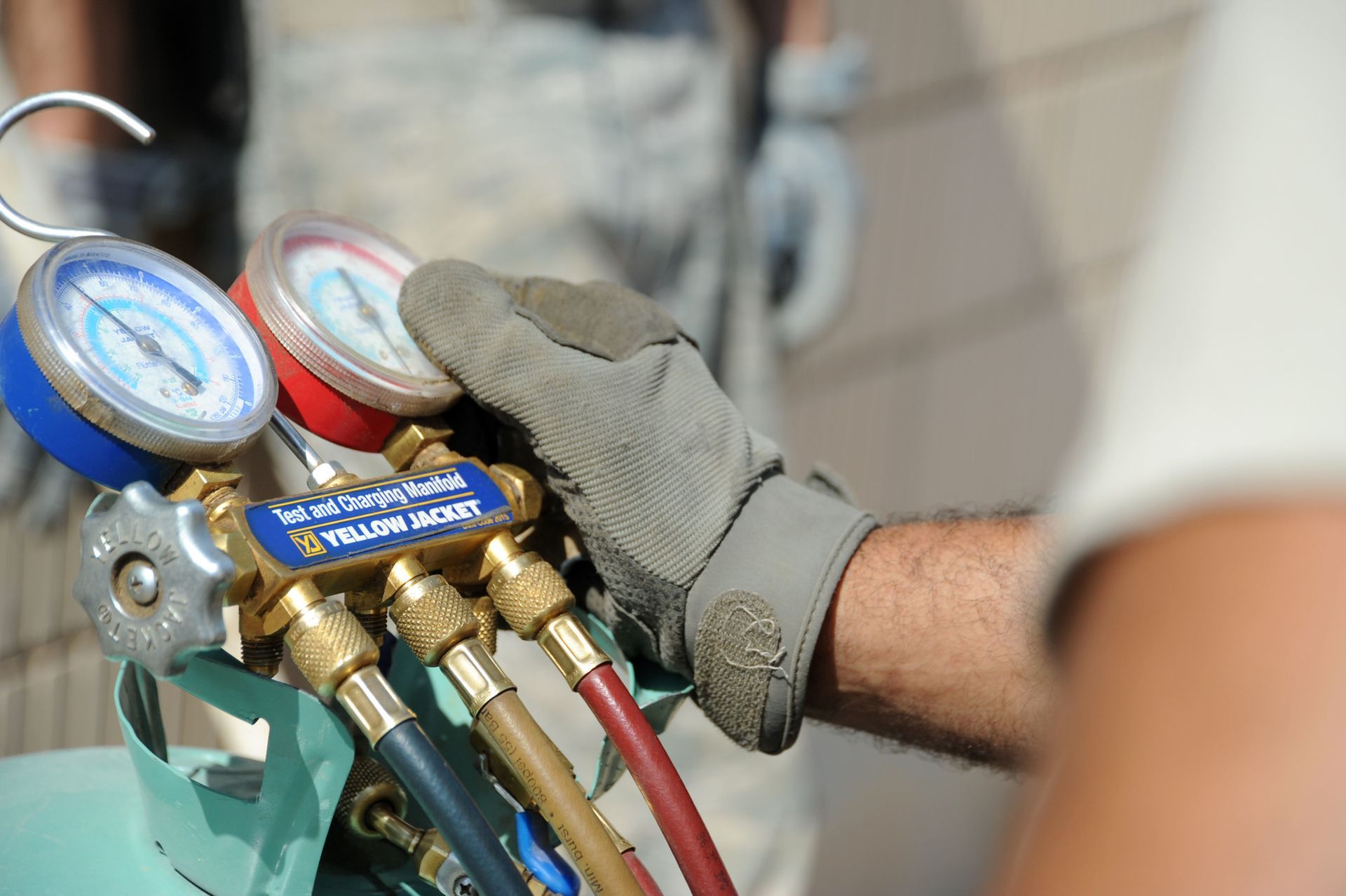 A man wearing a glove is holding a bunch of gauges.
