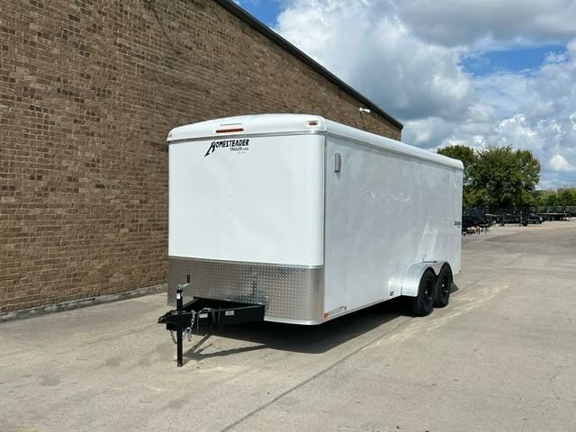 Enclosed cargo trailer parked outside a brick building, ideal for moving, hauling, or equipment transport.