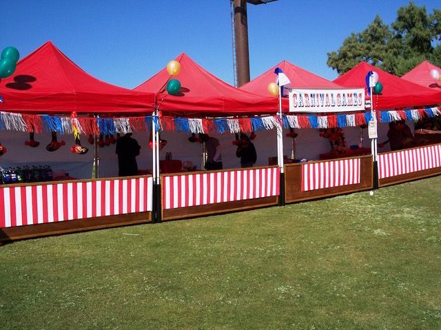 Colorful carnival booth setup with red and white striped tents, perfect for festivals and corporate events.