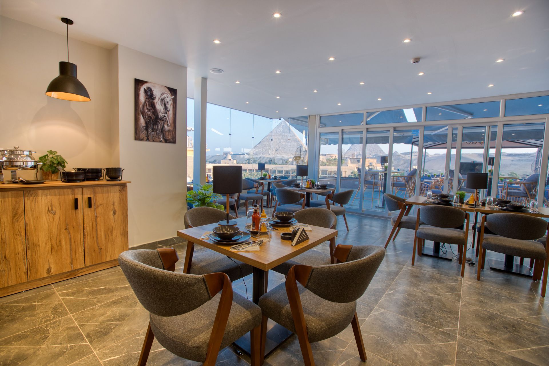 A restaurant with tables and chairs and a large window.