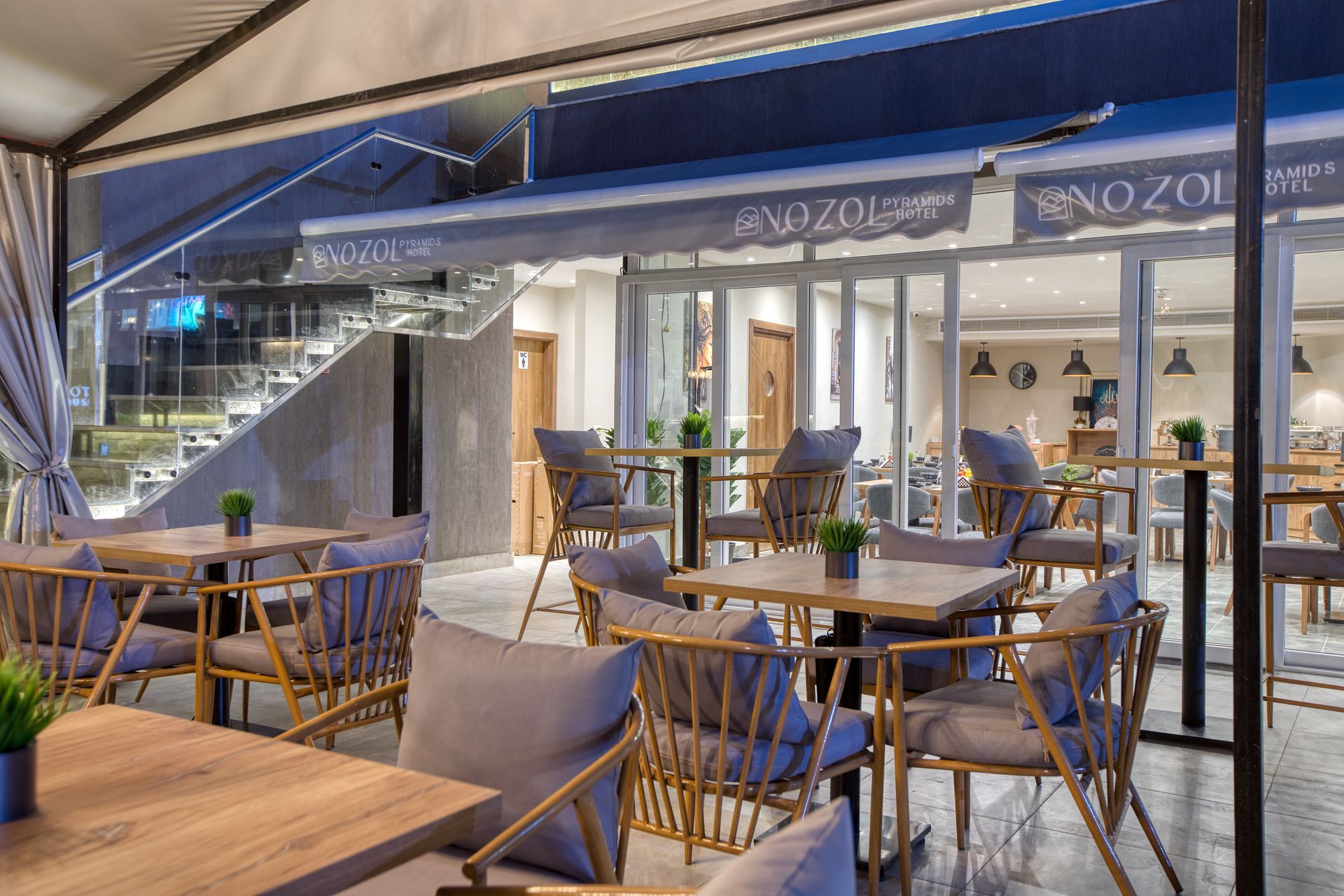 There are many tables and chairs in the restaurant.