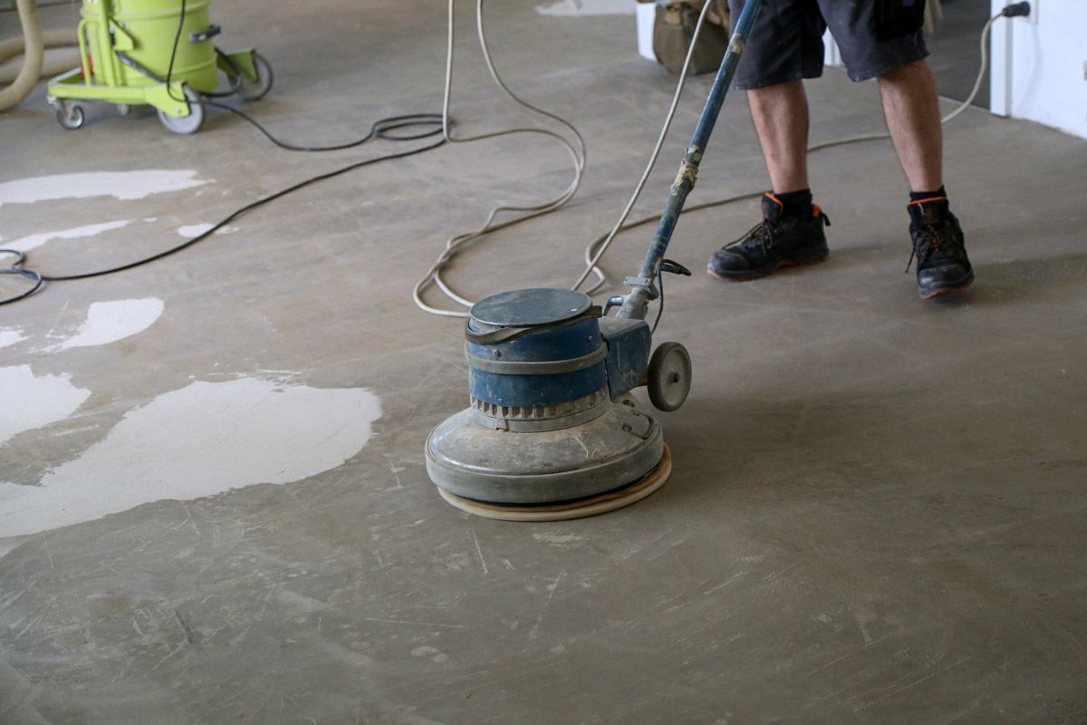 A Person Is Using a Machine to Polish a Concrete Floor — Petone, Waikato — Industrial Floor Care