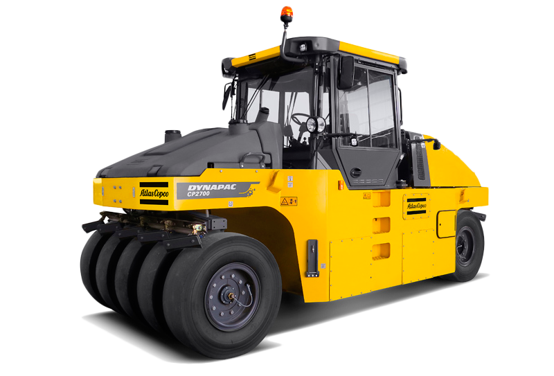 Yellow Dynapac soil compactor on a white background, with large tires and a cab.