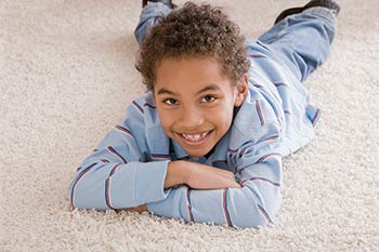 Flooring Experts —Boy Laying Down on Carpet in Wilmington, DE