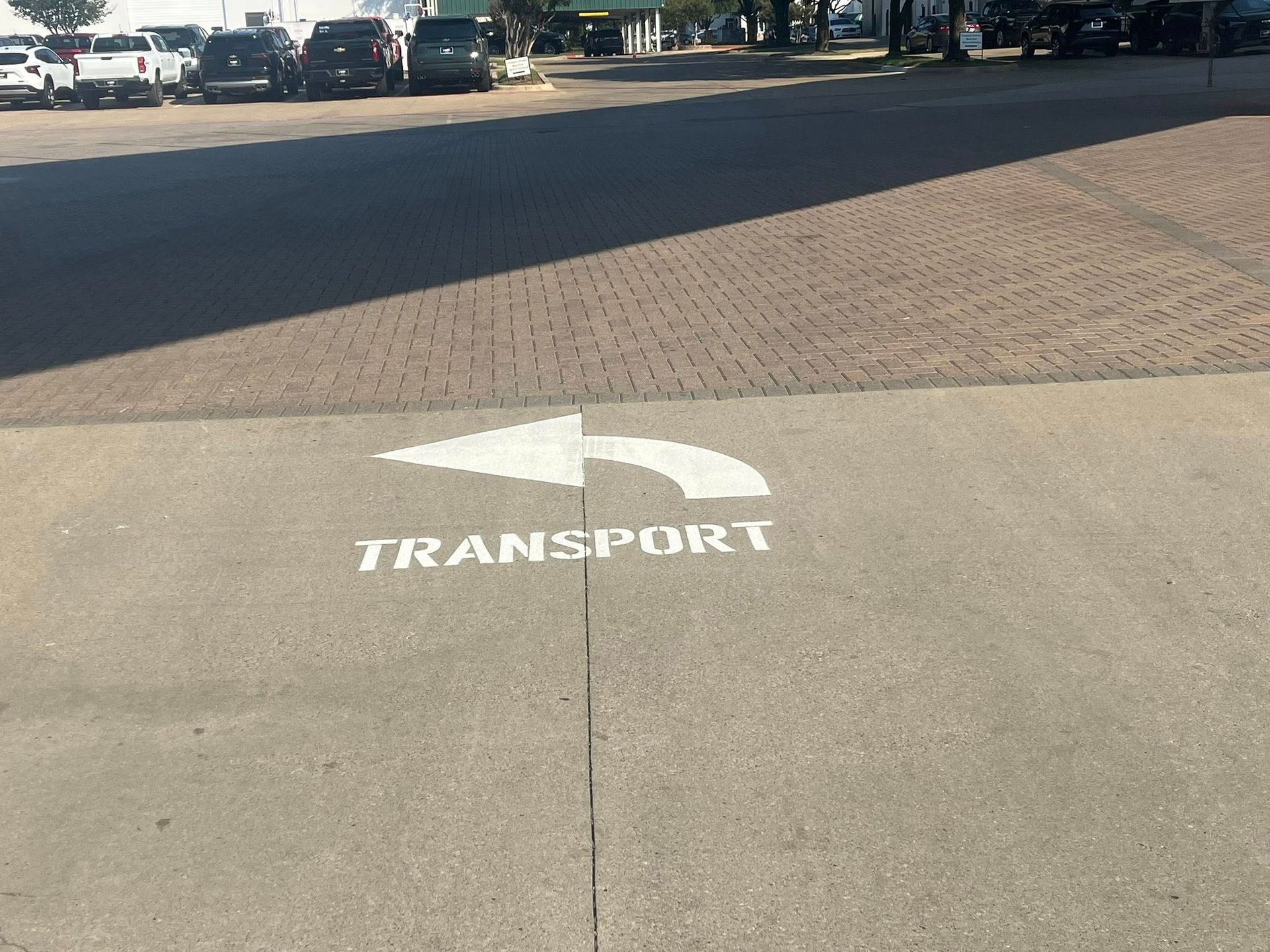 Arrow sign on pavement, directing to 