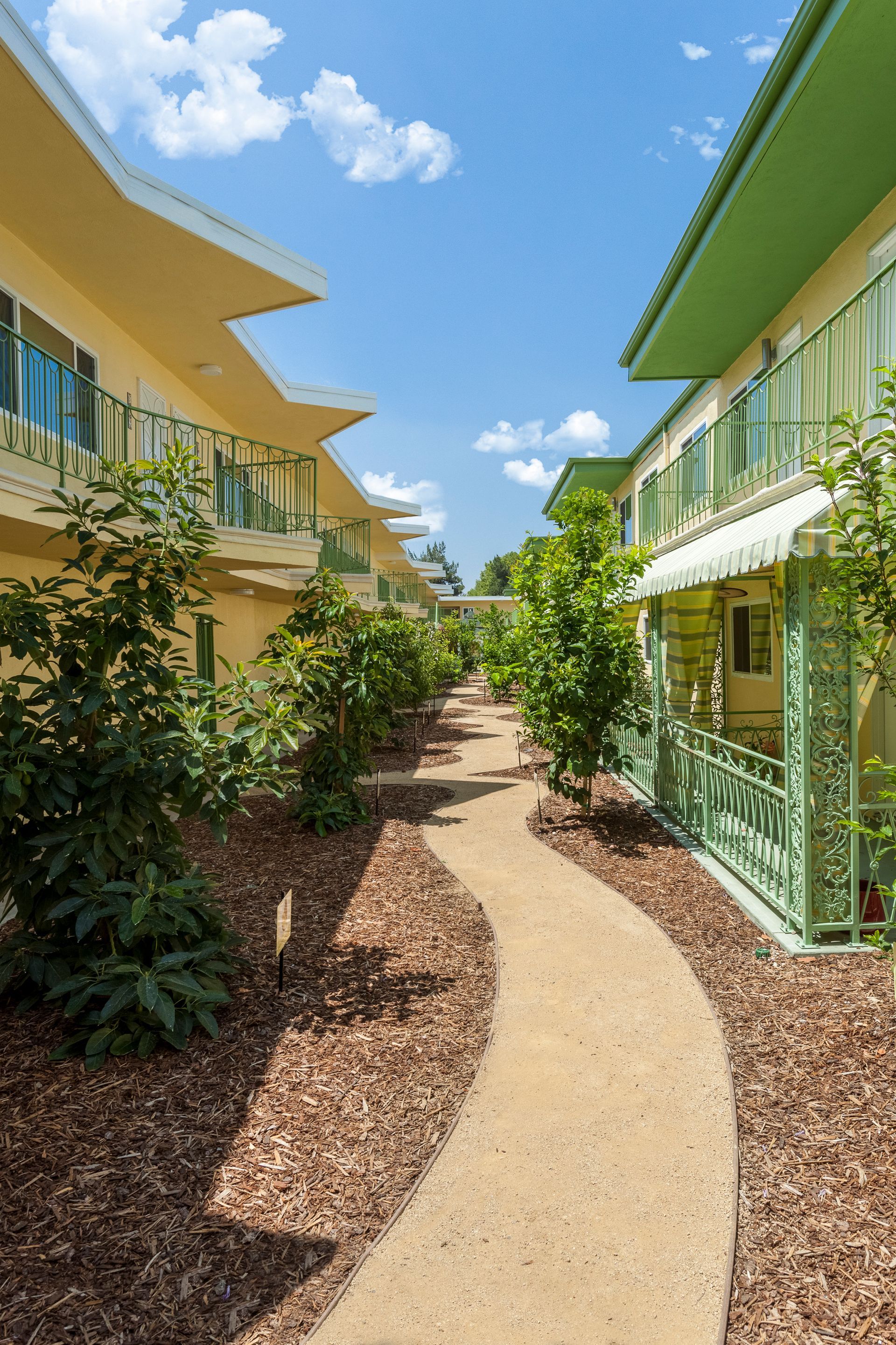 A walkway between two buildings with a blue sky in the background.