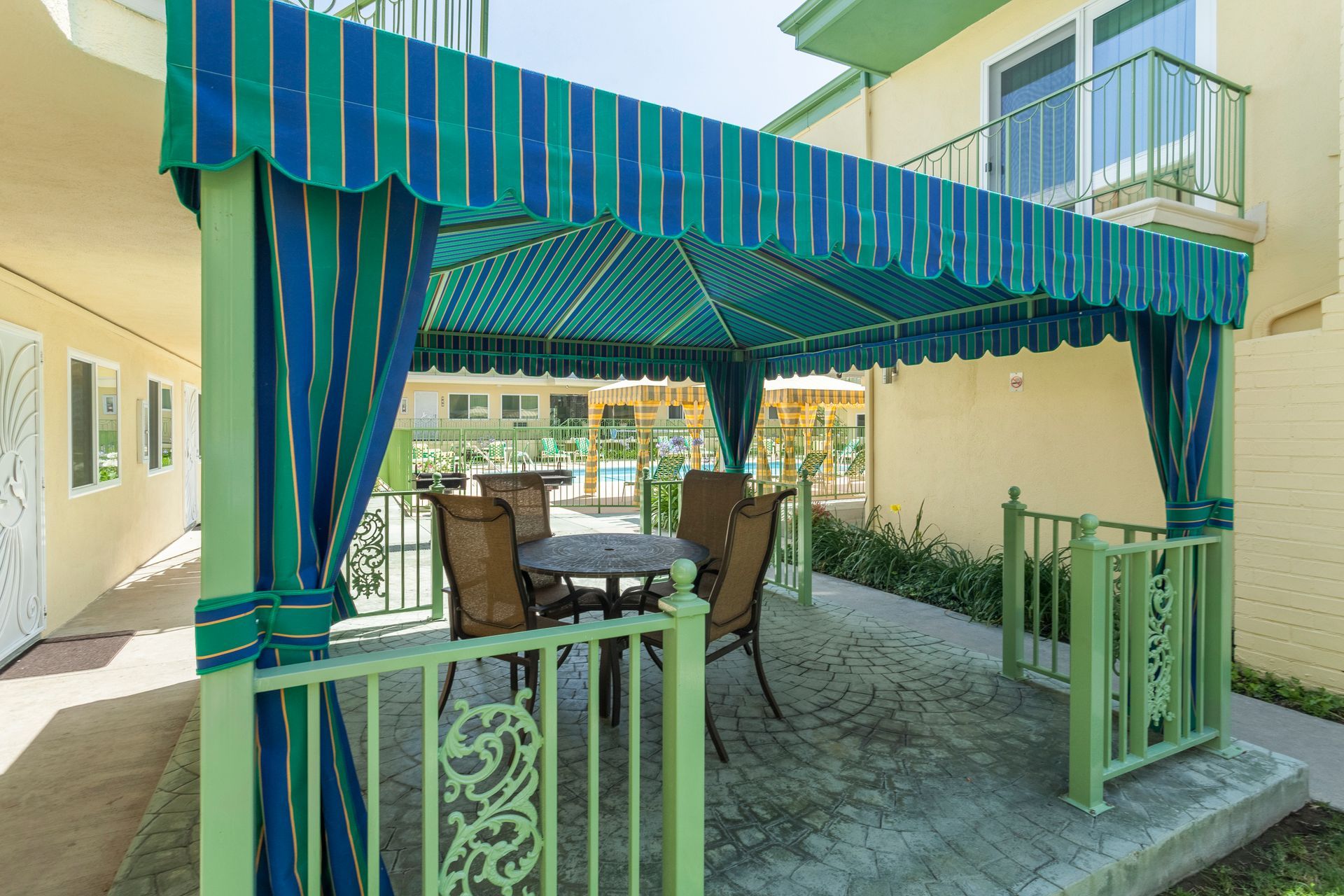 There is a gazebo with a table and chairs underneath it.