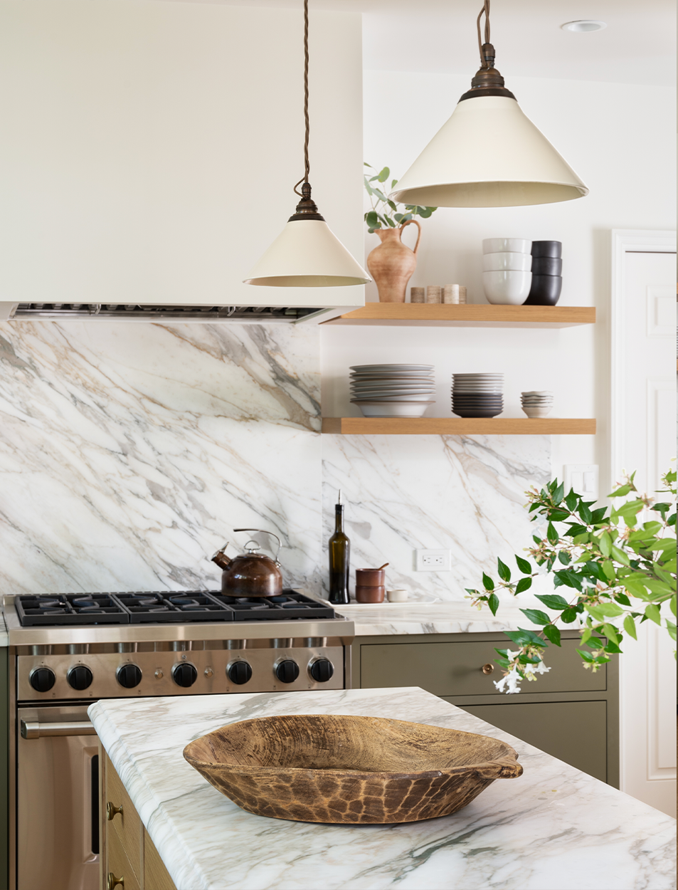 A kitchen with a stove and a bowl on the counter