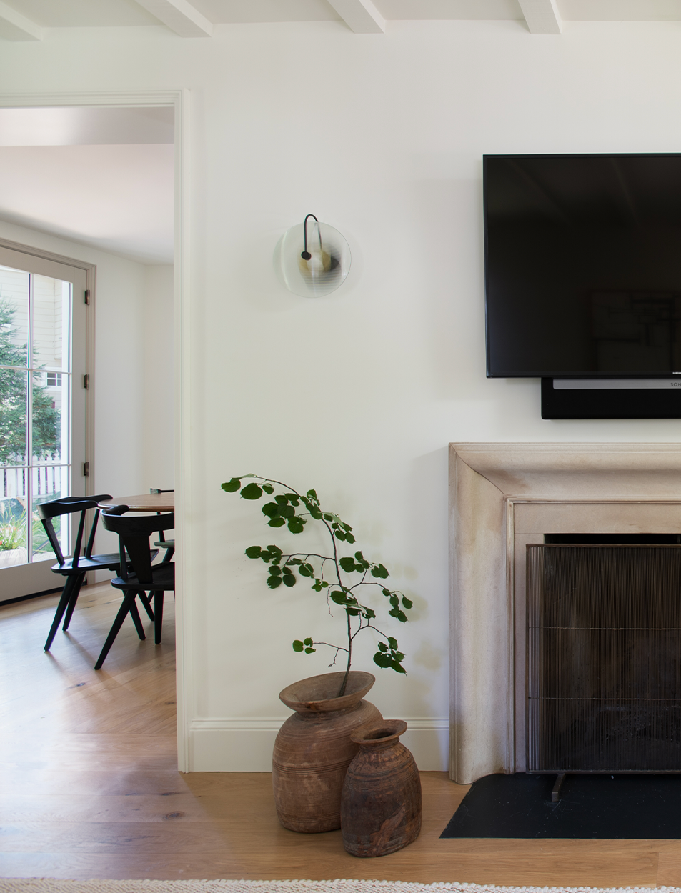 A living room with a fireplace and a flat screen tv