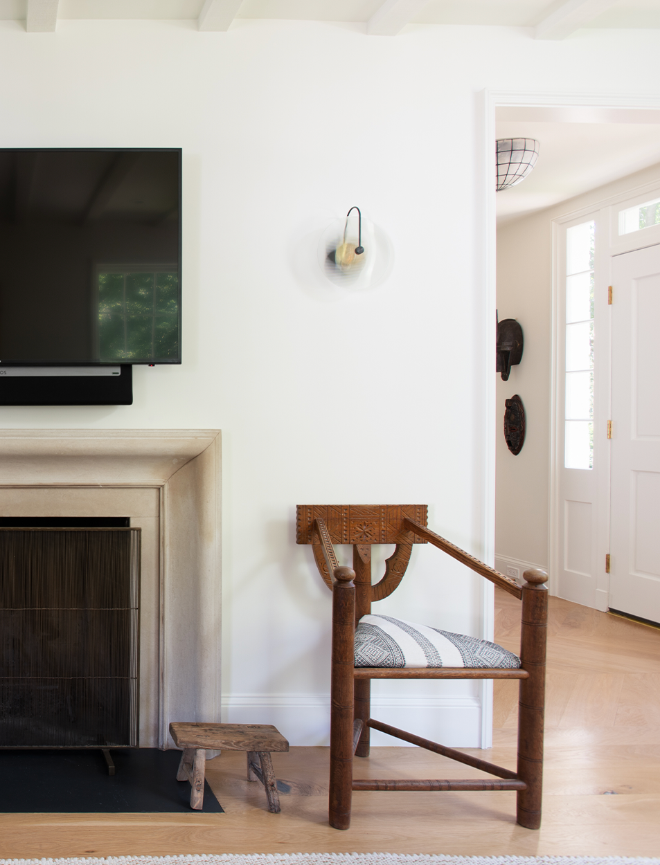 A living room with a chair and a flat screen tv
