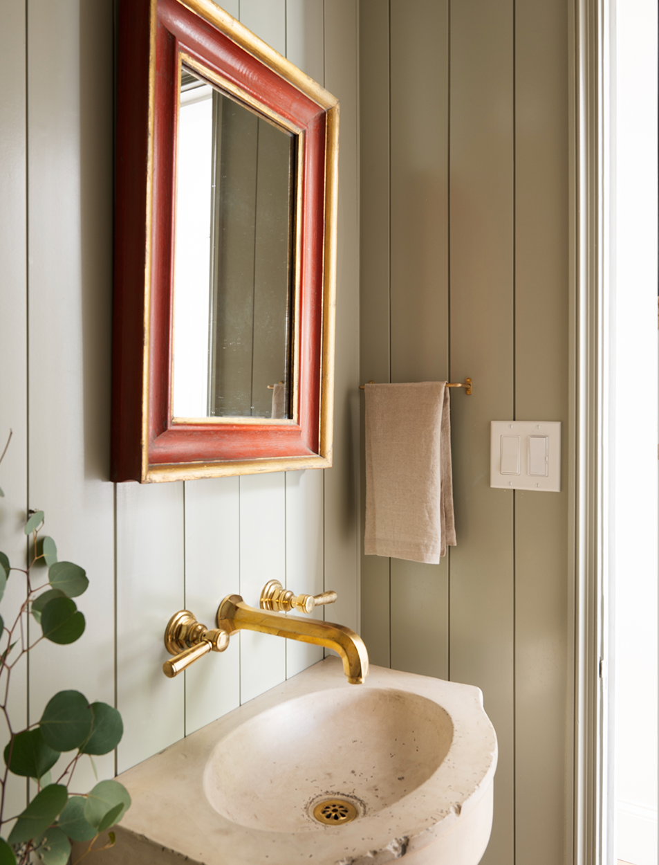 A bathroom with a sink and a mirror on the wall