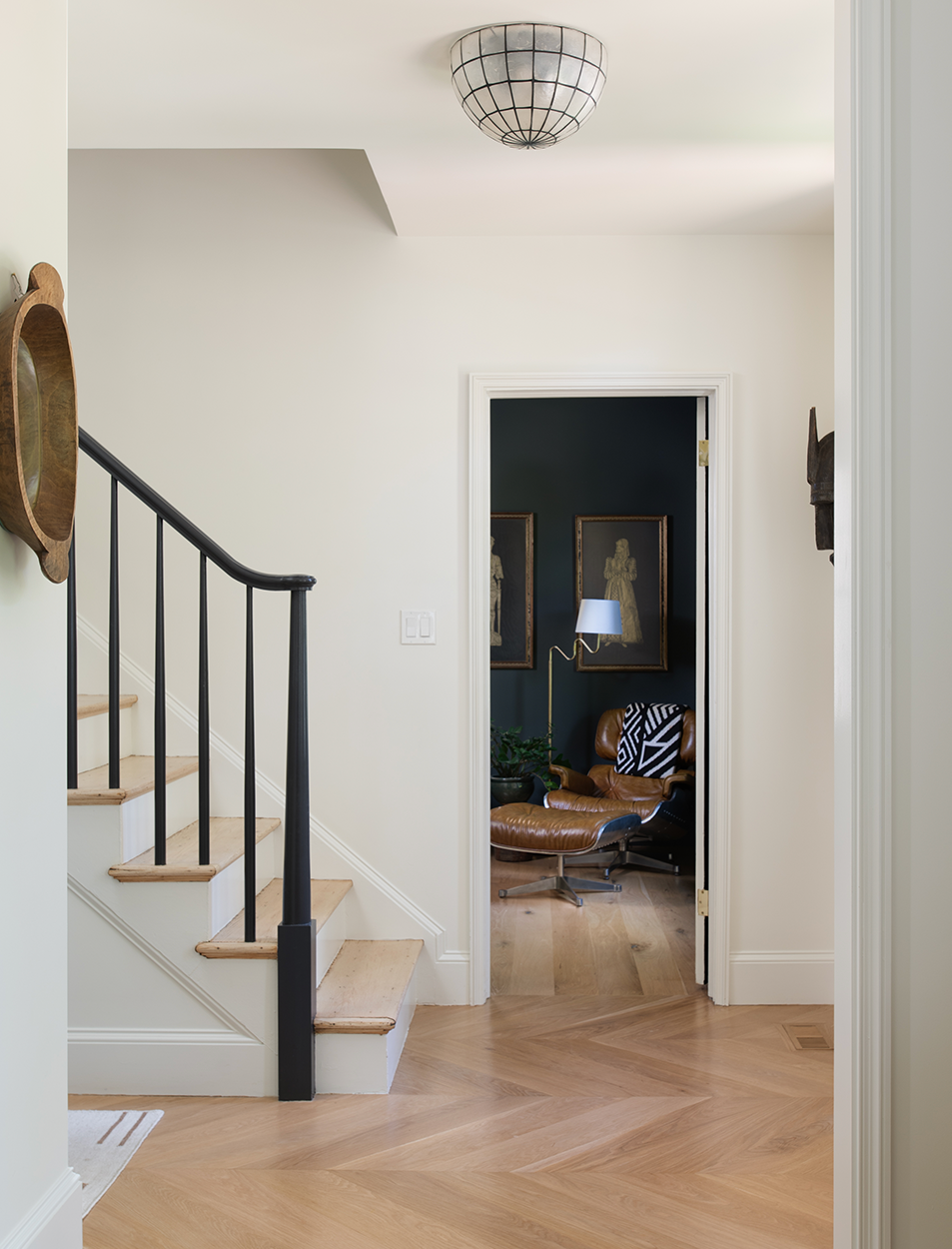 A hallway with stairs leading up to a living room
