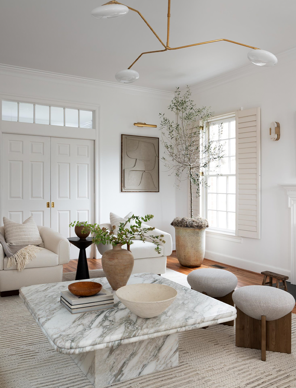There is a marble coffee table in the middle of the living room.