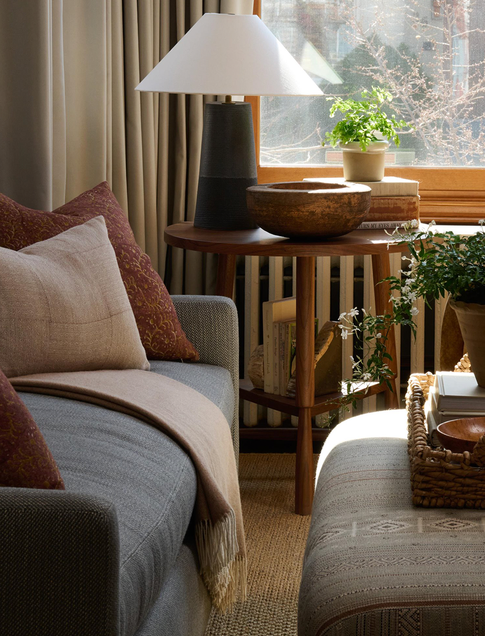 A living room with a couch a table and a lamp