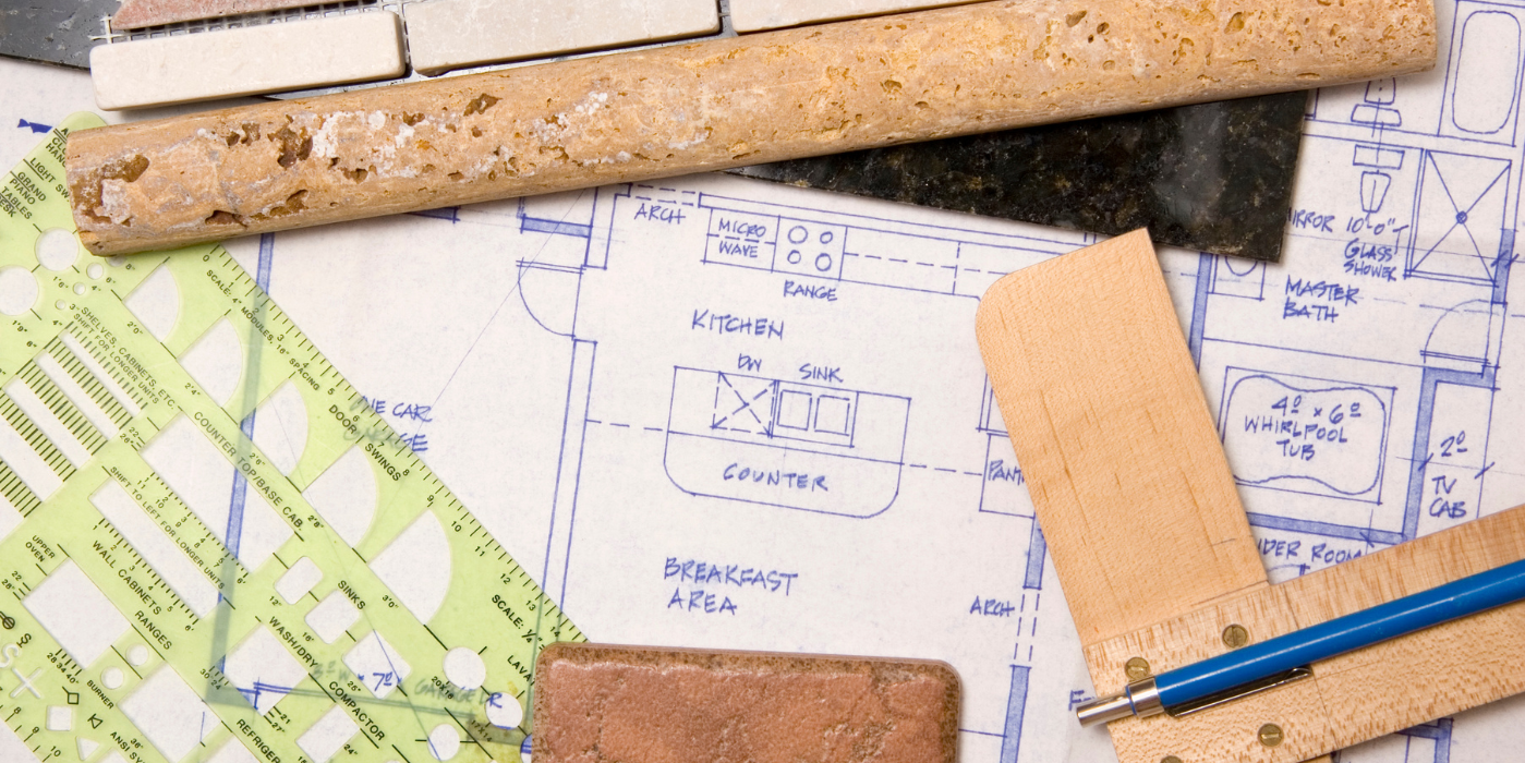 There are two chimneys on the roof of a house.