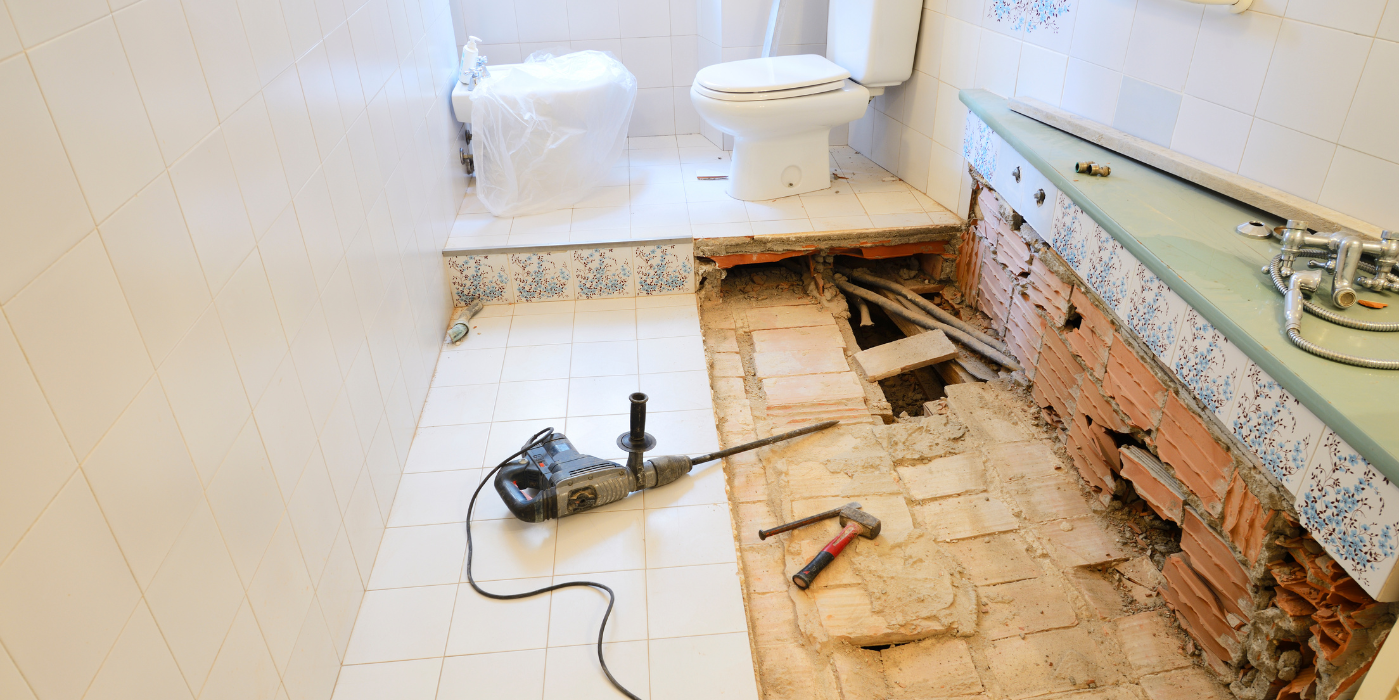 There are two chimneys on the roof of a house.