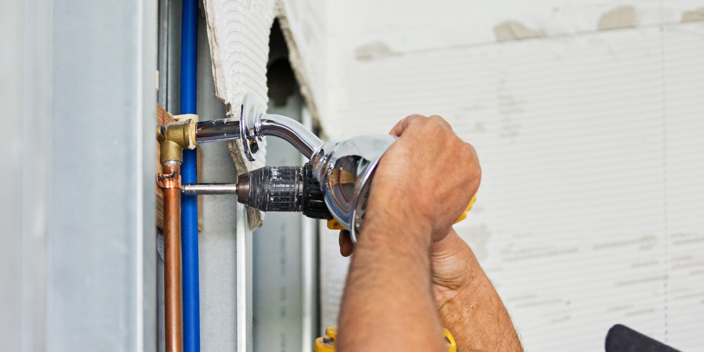 There are two chimneys on the roof of a house.