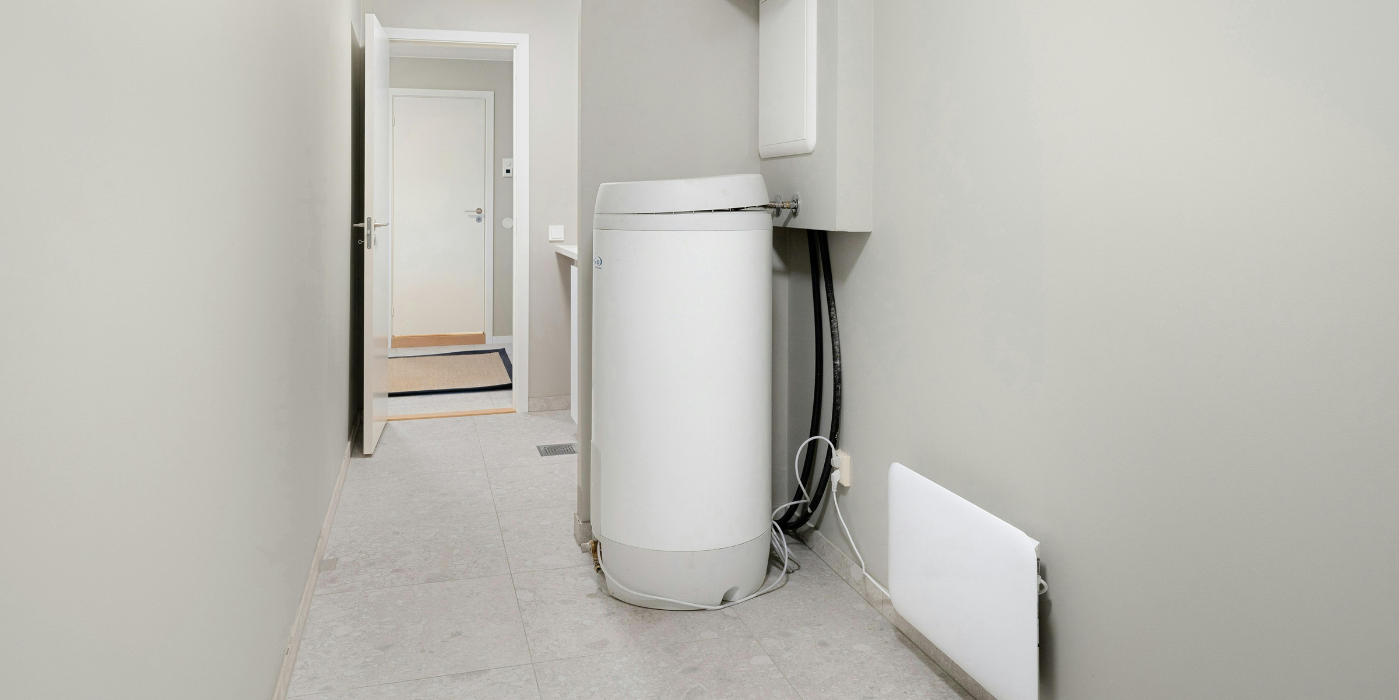 There are two chimneys on the roof of a house.