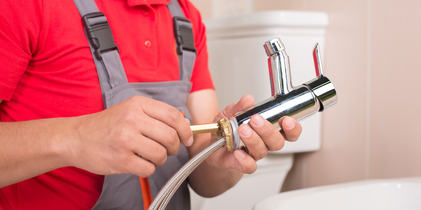 There are two chimneys on the roof of a house.