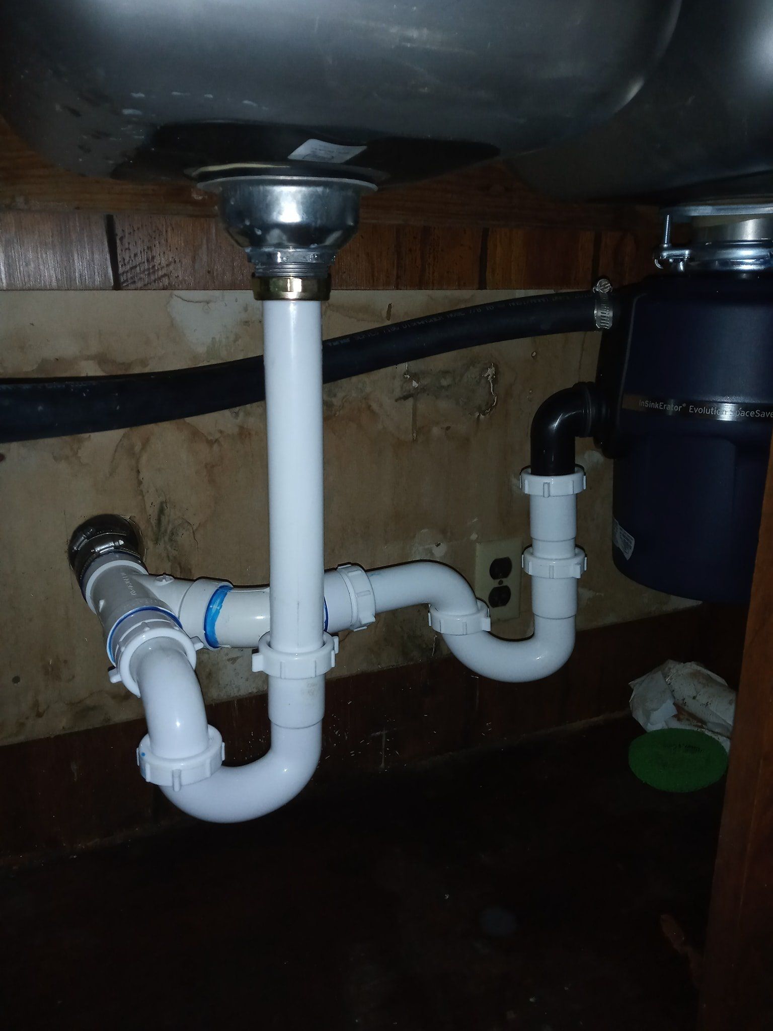 A sink with a garbage disposal underneath it