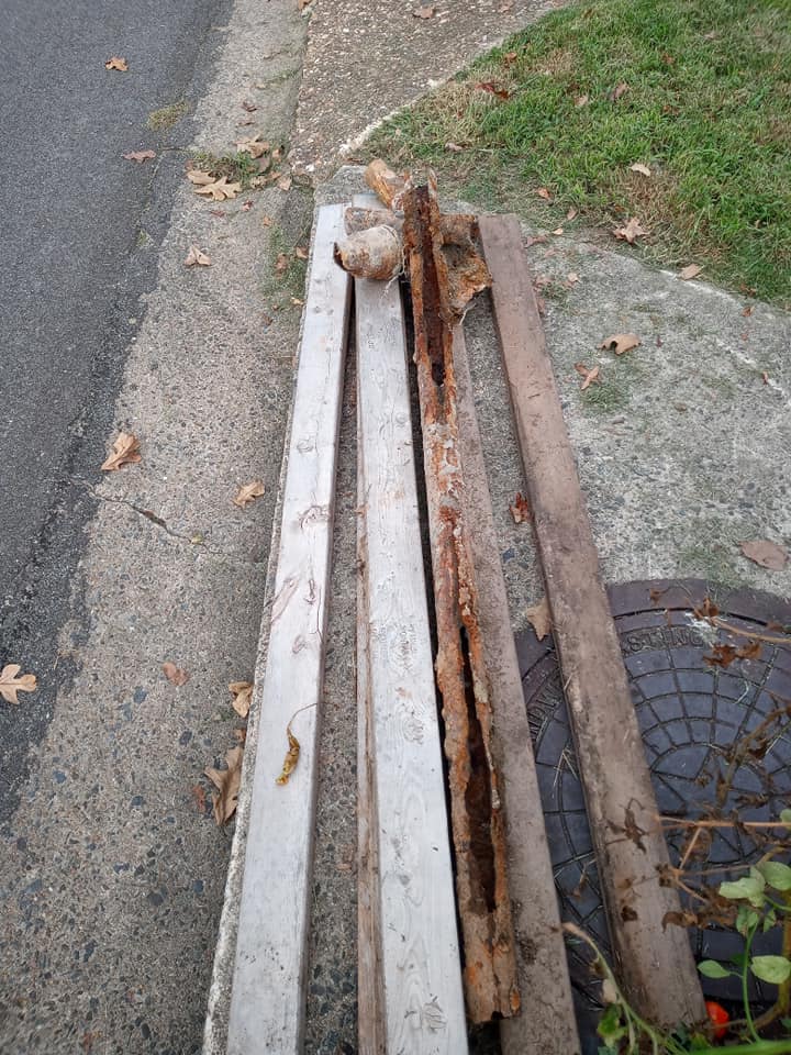 Two pieces of wood are sitting on the side of the road.