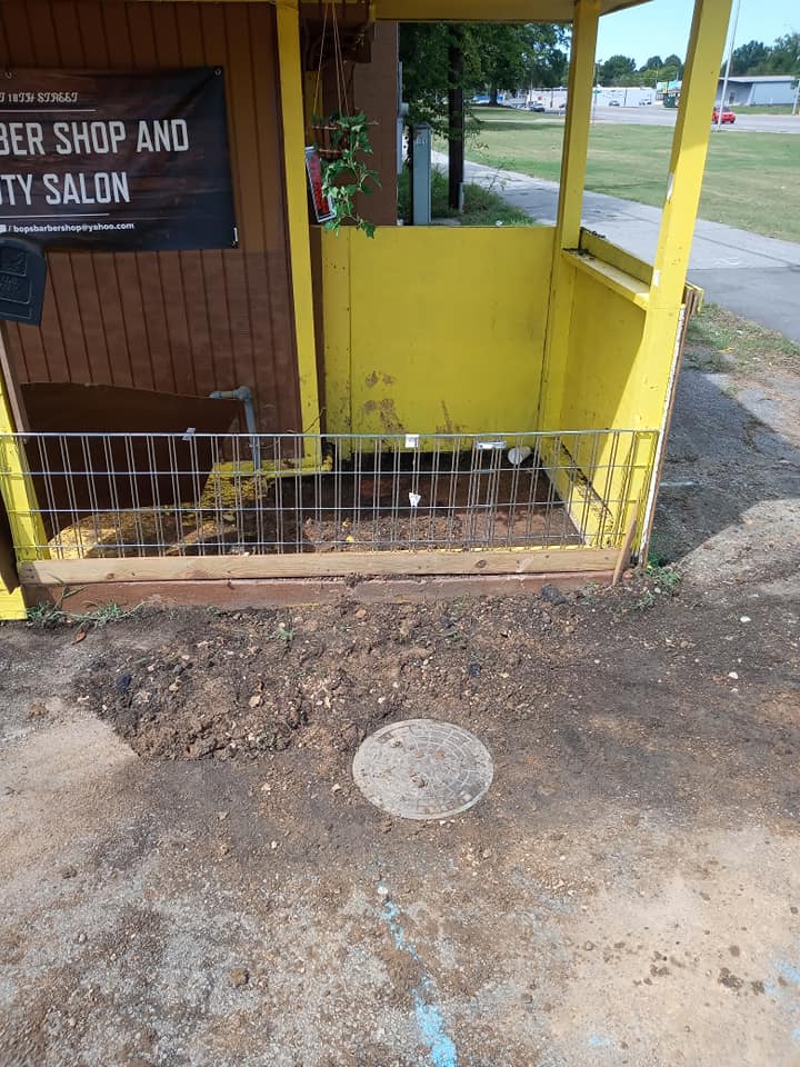 A yellow building with a sign that says barber shop and beauty salon
