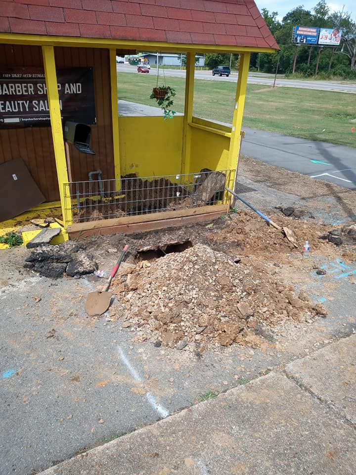 A yellow building with a red roof is being demolished.