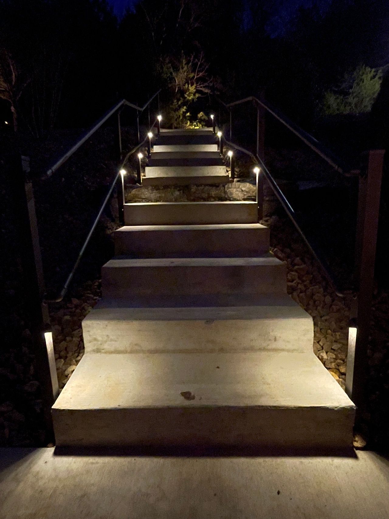 A set of stairs that are lit up at night.