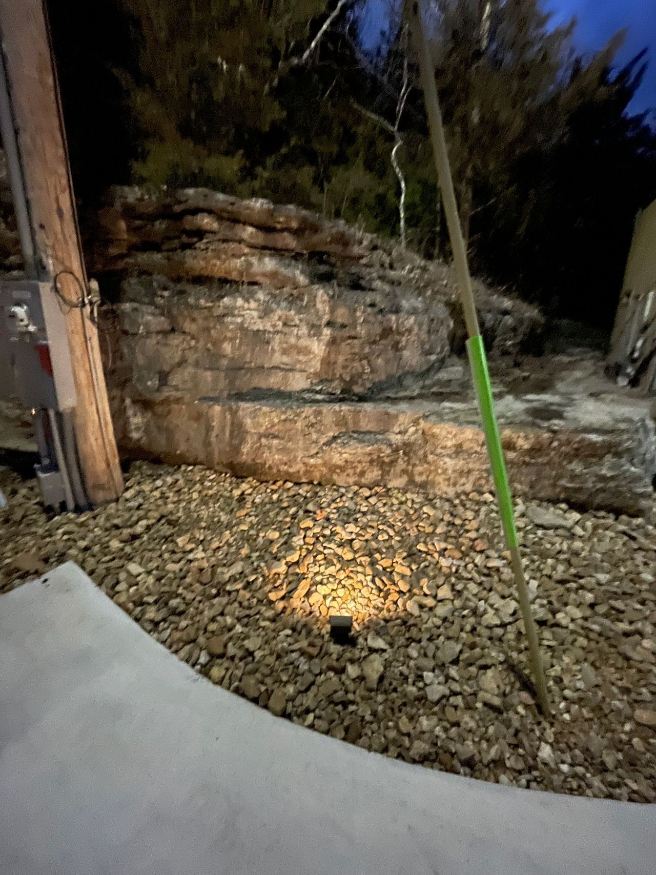 A light is shining on a pile of rocks.