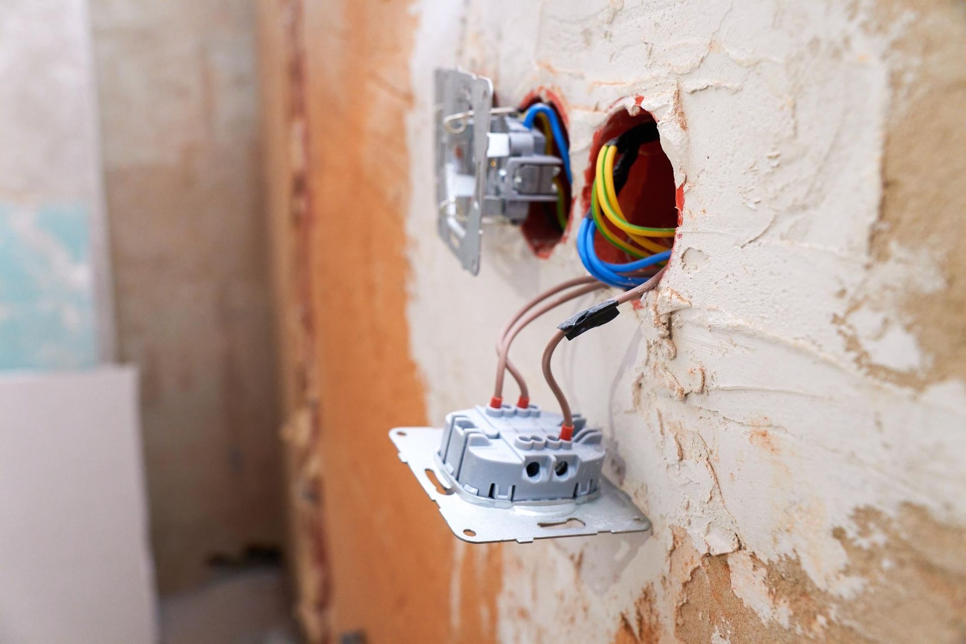 Two light switches are being installed in a wall.