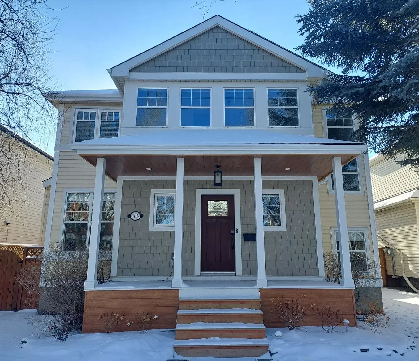 A house with a porch and stairs in the snow