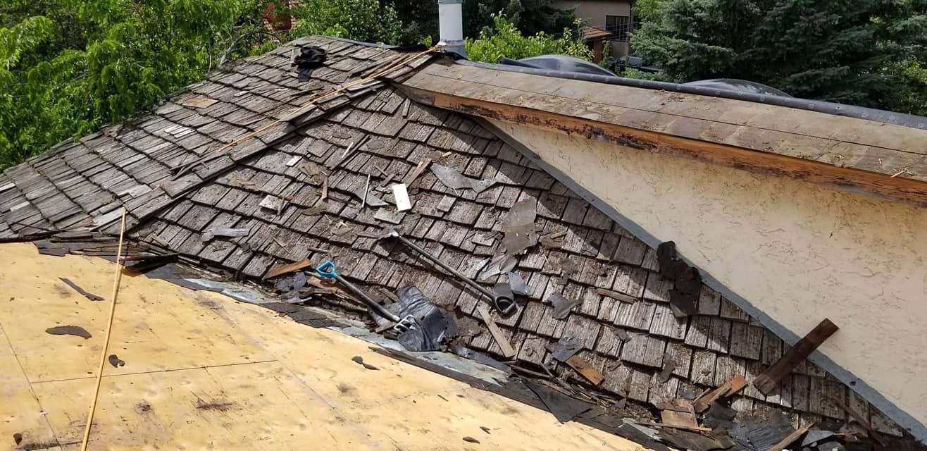 A roof with a lot of shingles on it is being repaired.