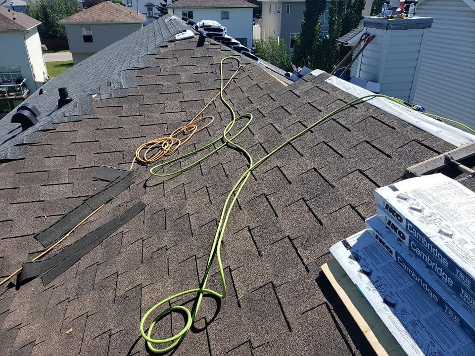 A roof with a rope attached to it is being repaired.