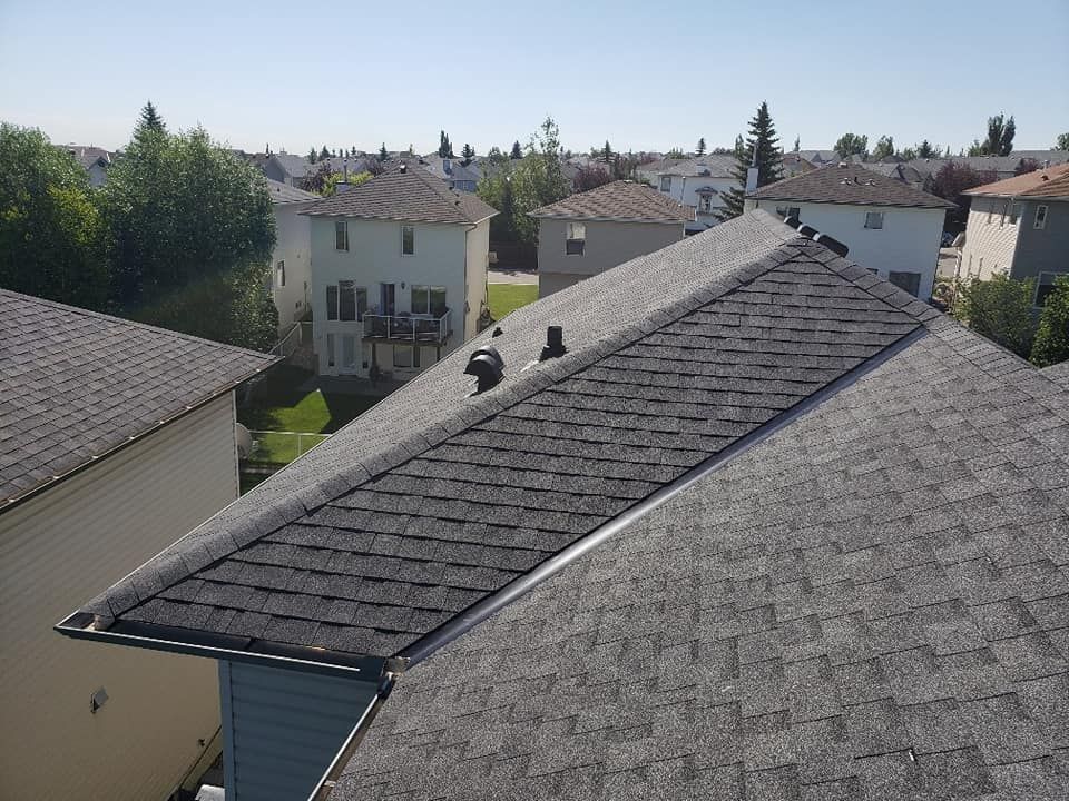 An aerial view of a roof of a house in a residential area