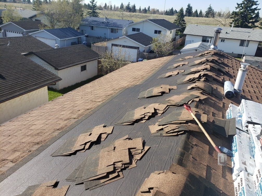 A roof with a lot of shingles on it is being repaired.