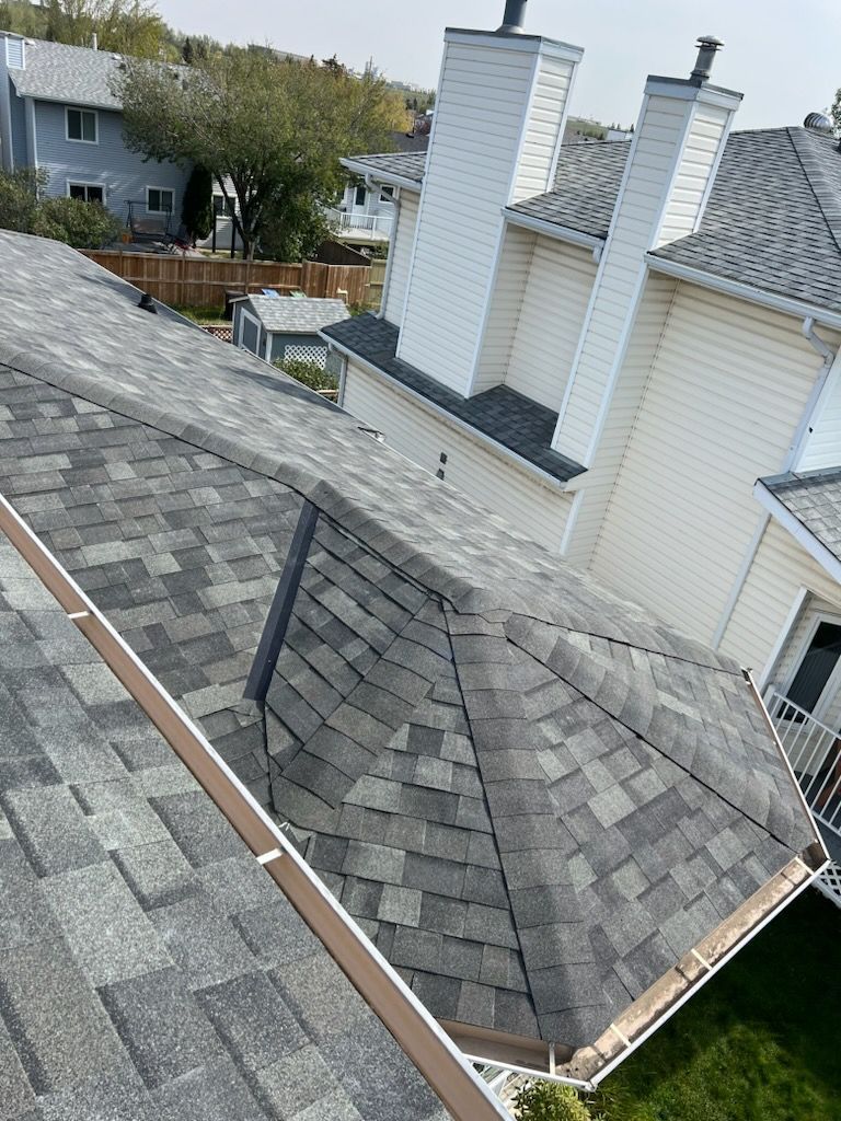 An aerial view of a roof with gutters and chimneys.